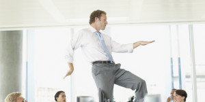Businessman dancing on cubicle desk