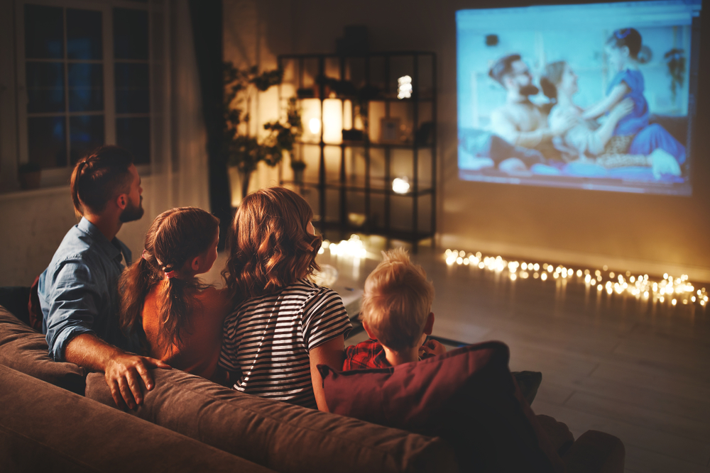 Family watching dance movies together on couch
